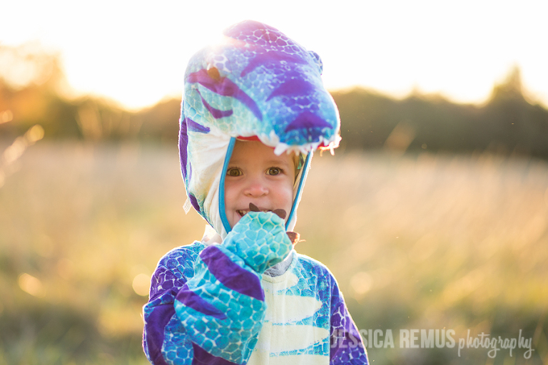 boy giggling dinosaur costume