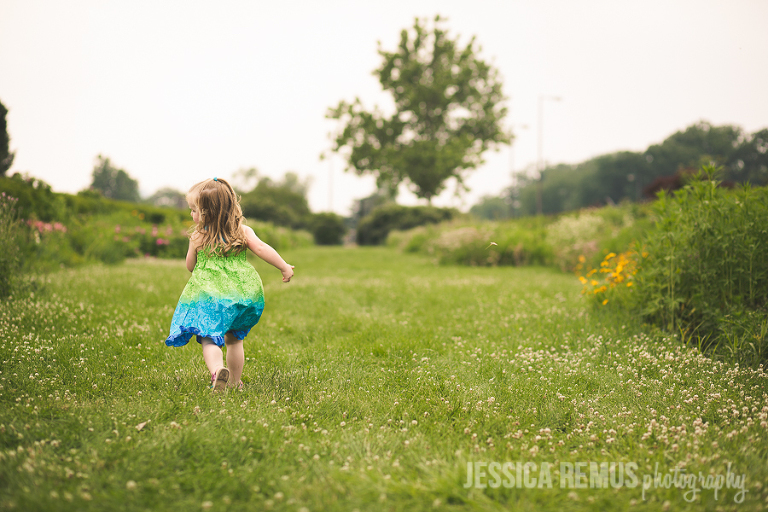little girl running in field