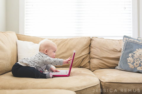 baby and laptop computer